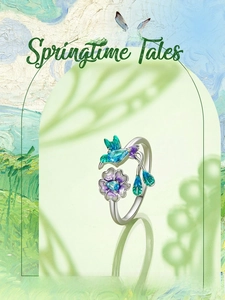 Detail of s925 silver open ring featuring a blue hummingbird and purple flower design
