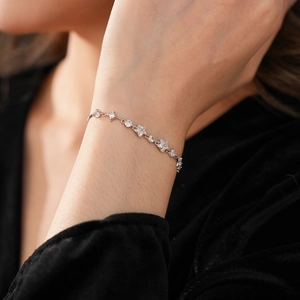 Close-up of sparkling zircon star bracelet on wrist with elegant silver-tone finish