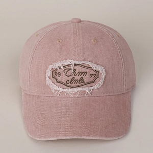 Detail of pink vintage cotton baseball cap with distressed patch and letter embroidery