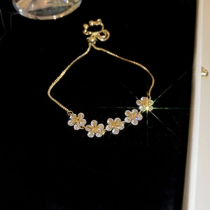 Macro view of gold plated star flower slider bracelet with sparkling zircon stones