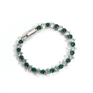 Detail of silver bracelet featuring green round stones and white marquise cut zircons