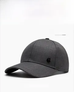 Detail of dark grey baseball cap showing fine textured fabric and circular G logo
