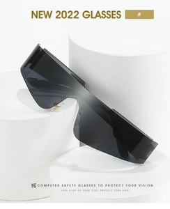 Detail of black one-piece rimless wrap-around sunglasses on minimalist geometric display