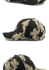 Detailed views of floral jacquard embroidery on a black vintage baseball cap