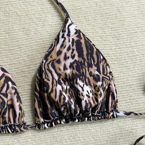 Close-up of leopard print triangle bikini top with ruffled edges and contrast stitching