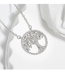 Macro view of silver Tree of Life pendant with sparkling zircons on stone background