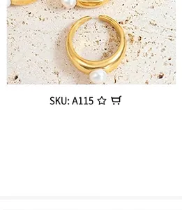Close-up of golden open ring with white round pearl on matte stone background