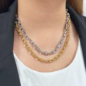 Industrial style U-link chain necklace set in gold and silver finish on a model