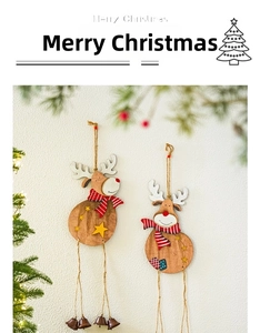Close-up of wooden reindeer ornaments with striped scarves and small metal bells