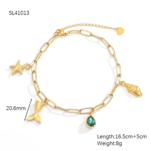 Detailed macro view of 18K gold plated marine charms with starfish and sea shell pendants