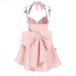 Detailed back view of pink tweed dress with a large bow and sequin texture details
