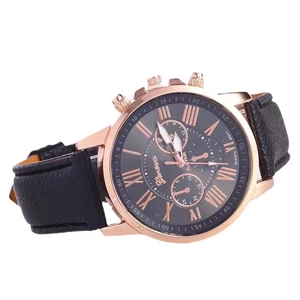 Detail of Geneva quartz watch with black leather strap and rose gold Roman dial