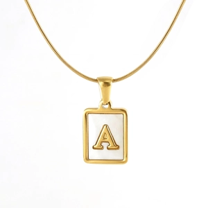 Detailed close-up of a golden rectangle pendant with white inlay and a 3D letter A design