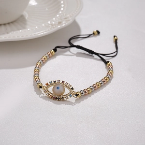 Macro shot of evil eye bracelet with colorful zircons and adjustable tri-color beads