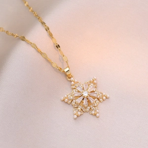 Gold rotating orchid necklace with sparkling clear crystals and small pearls pendant