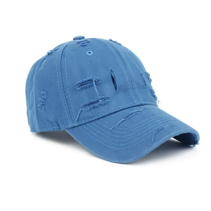 Close-up of distressed navy blue baseball cap with retro frayed holes and cotton texture