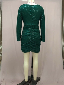 Detail of emerald green sequin dress showing the back fit on a tailor mannequin