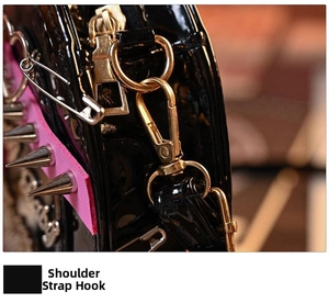 Macro detail of gothic punk heart bag featuring gold lobster clasp and metal studs