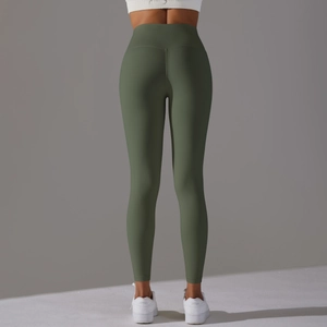 Detail view of olive green high-waisted yoga pants showing ergonomic seams and butt-lifting