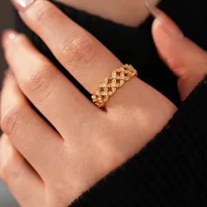18k gold plated hollow flower ring with cubic zirconia stones on model's finger
