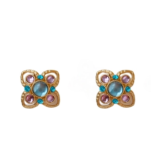 Gold plated vintage flower stud earrings with purple and blue crystals on white background