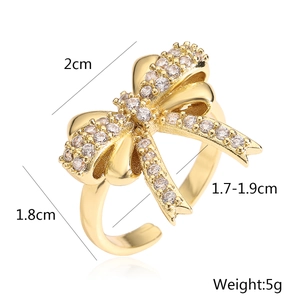 Detail showing 18K gold bow ring size measurements and zircon setting on white background