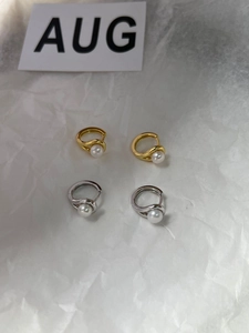 Detail of S925 sterling silver pearl hoop earrings in gold and silver finishes