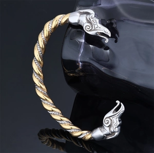 Macro shot of Viking dragon head bangle with two-tone gold and silver metallic texture