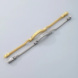 Detail view of gold and silver stainless steel woven dragon chain bracelets with engravings