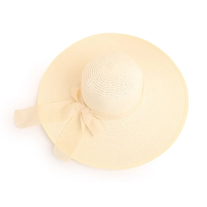 Detail of fine straw texture and wide ribbon bow on a stylish sun protection beach hat
