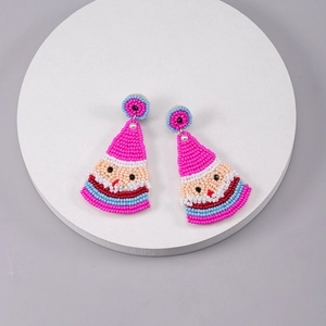 Detailed view of handmade beaded earrings featuring creative Santa Claus holiday designs