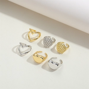 Close-up of a 6-piece heart and V-shaped ring set in gold and silver finishes