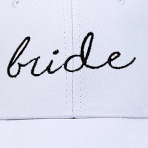 White baseball cap featuring elegant black bride script embroidery for autumn winter