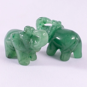 Close-up of two green jade elephant figurines with smooth texture and polished finish