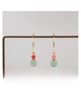 Detail of pink and green beaded gold hoop earrings with a vintage Chinese aesthetic style