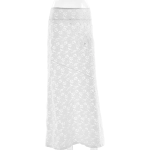 Detailed view of white floral lace fabric and elastic waistband on a maxi skirt