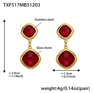 Detail view of gold stainless steel earrings with red glass stones and size measurements
