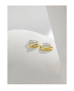 Macro shot of S925 sterling silver hoop earrings with two-tone gold and silver finish