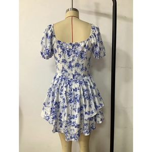 Detail of floral printed mini dress with puff sleeves and layered ruffle hem