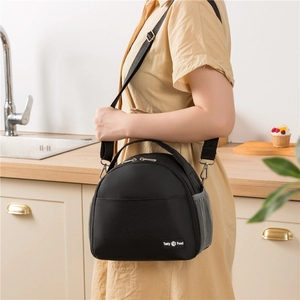 Black insulated lunch bag with shoulder strap and Tasty Food label shown in kitchen