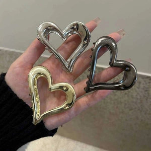Three-piece metal heart-shaped hair claw set in gold, silver, and gunmetal finishes