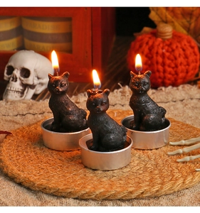 Detail of black cat shaped craft candles with silver base for Halloween decorations