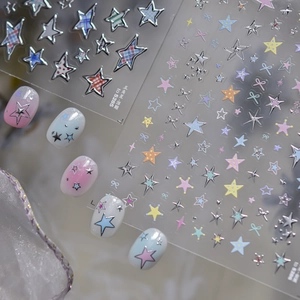 Macro detail of star and bow 3D nail art stickers with silver embossed edges for DIY manicure