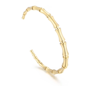 Elegant gold bamboo segment open bangle in polished metal for a minimalist jewelry look
