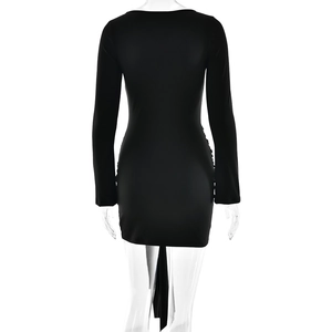 Detailed back view of a slim-fit black long sleeve dress with slit hem and lace-up design