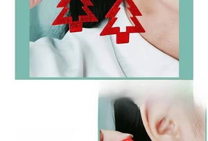 Detail of red glitter Christmas tree earring worn to show size and sparkle