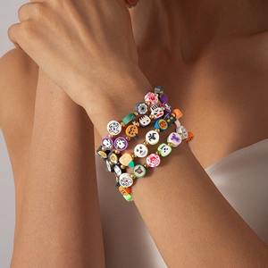 Halloween layered beaded bracelet set featuring pumpkin, ghost and skull charms
