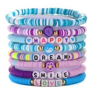 Detailed view of colorful clay bead bracelets with Happy, Dream, Smile, and Love charms