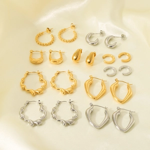 French vintage 18K gold plated and silver stainless steel earrings set on beige silk