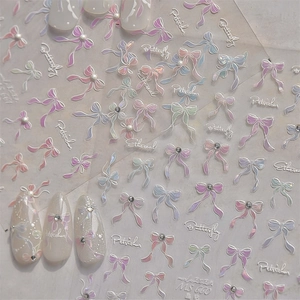 Macro view of crystal butterfly nail art stickers with 3D bows and iridescent rhinestones